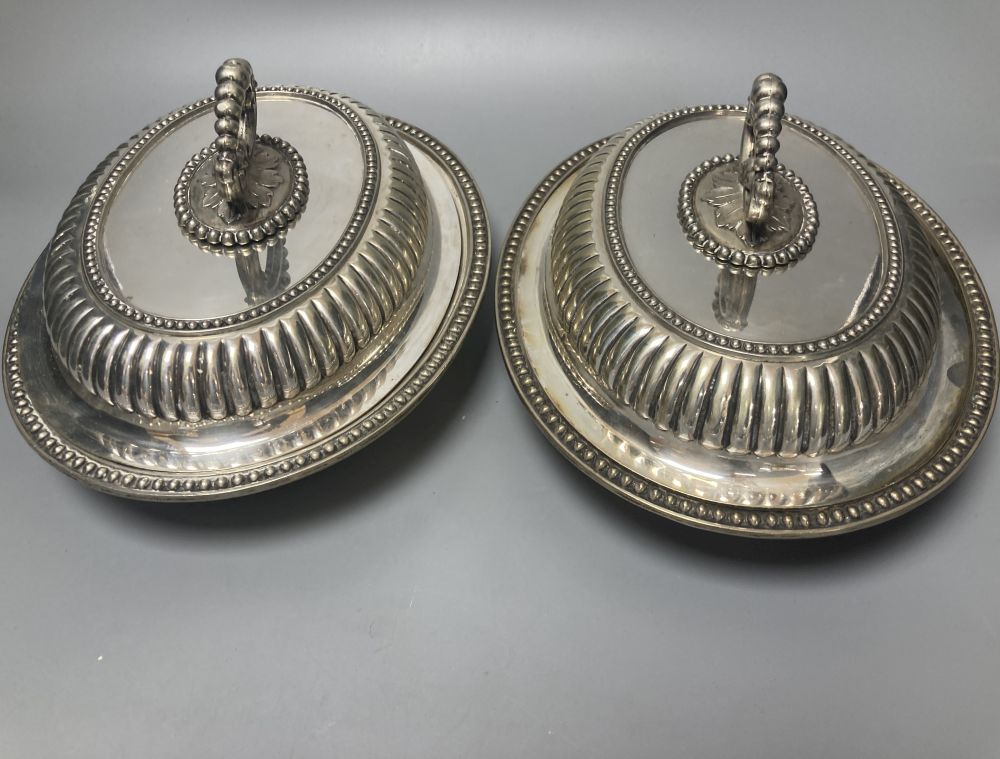 A pair of silver plated oval entree dishes, with covers and detachable handles, 29cm
